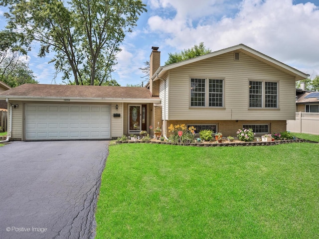 18902 Jonathan Ln, Homewood, IL 60430 - split level home with driveway, a chimney, an attached garage, and brick siding