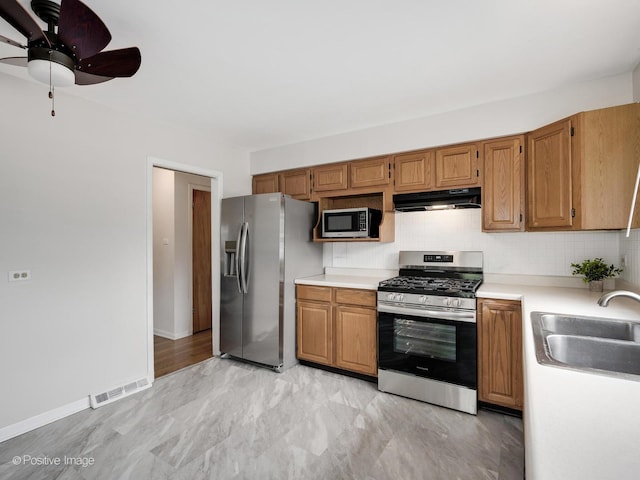 18902 Jonathan Ln, Homewood, IL 60430 - kitchen with stainless steel appliances, under cabinet range hood, light countertops, backsplash, and ceiling fan