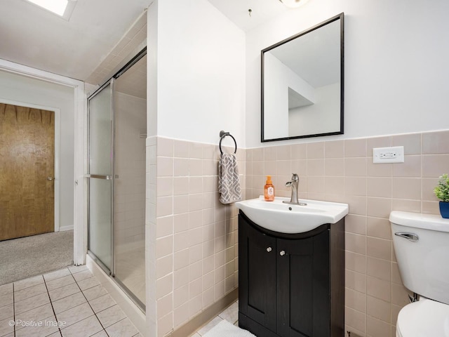 18902 Jonathan Ln, Homewood, IL 60430 - full bath featuring vanity, a stall shower, tile patterned flooring, wainscoting, and tile walls