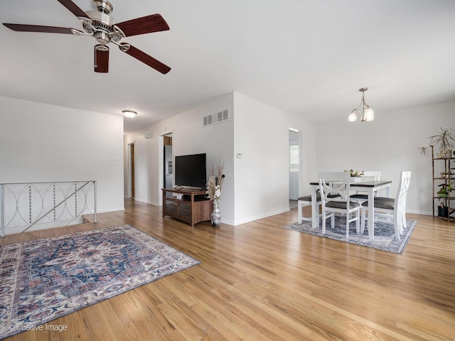 18902 Jonathan Ln, Homewood, IL 60430 - living room featuring ceiling fan, wood finished floors, and a chandelier