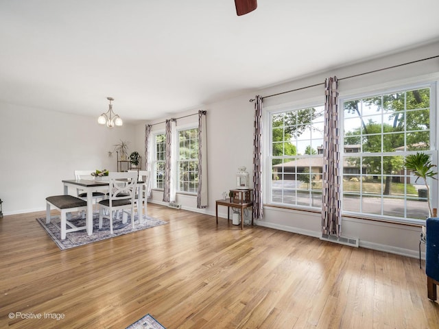 18902 Jonathan Ln, Homewood, IL 60430 - dining space with light wood finished floors, a chandelier, and ceiling fan