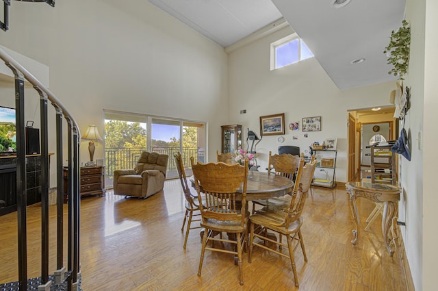 7050 183rd St Unit 409, Tinley Park, IL 60477 - dining area featuring a towering ceiling and light wood-style floors