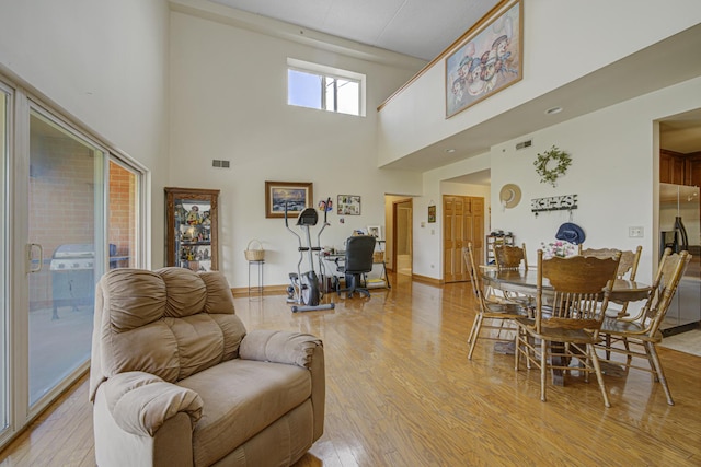 7050 183rd St Unit 409, Tinley Park, IL 60477 - living room featuring light wood-type flooring and a high ceiling