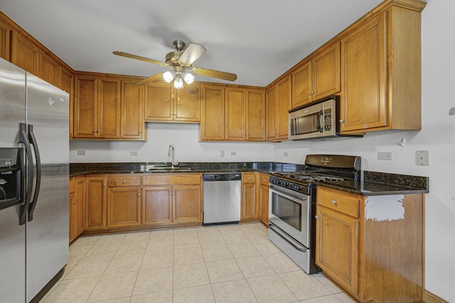 7050 183rd St Unit 409, Tinley Park, IL 60477 - kitchen featuring stainless steel appliances, a ceiling fan, brown cabinets, and dark stone countertops