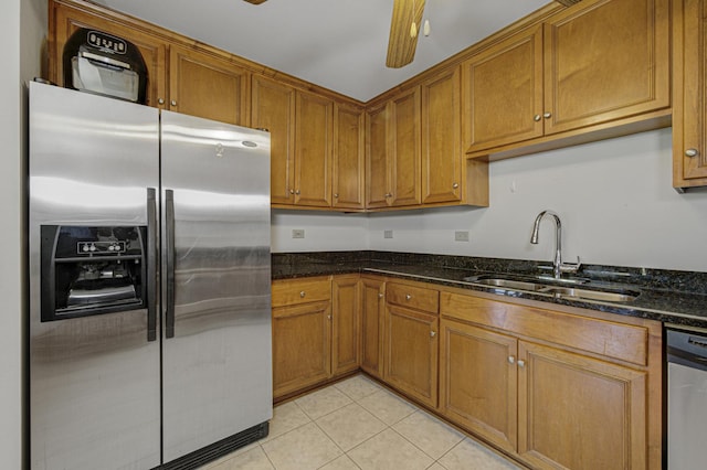 7050 183rd St Unit 409, Tinley Park, IL 60477 - kitchen featuring appliances with stainless steel finishes, brown cabinets, dark stone countertops, and light tile patterned floors