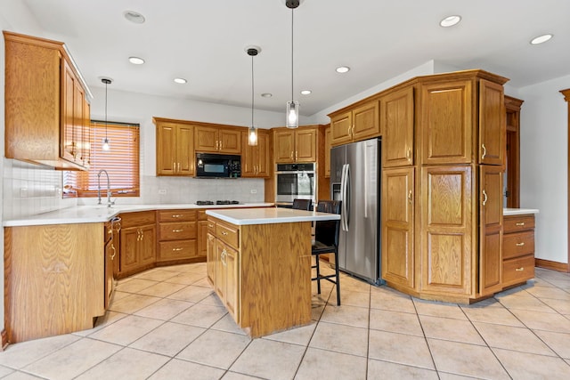 552 Waters Edge Dr, South Elgin, IL 60177 - kitchen with black appliances, a kitchen island, tasteful backsplash, a breakfast bar area, and light countertops