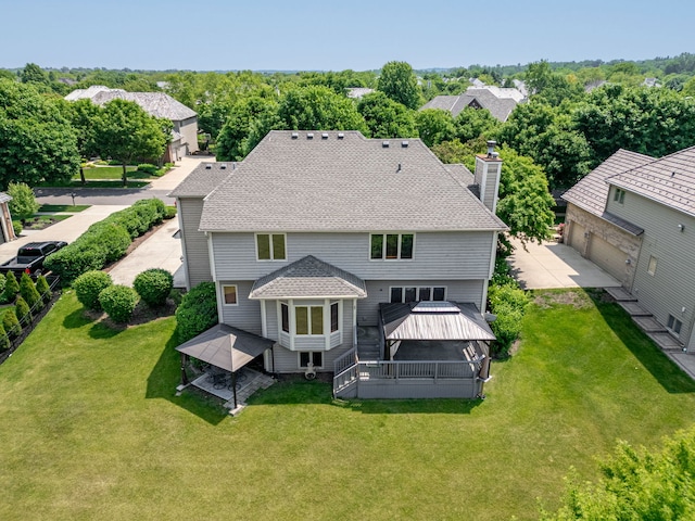 552 Waters Edge Dr, South Elgin, IL 60177 - back of property with a gazebo, a chimney, concrete driveway, a lawn, and a garage