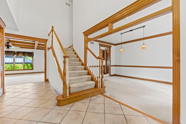 552 Waters Edge Dr, South Elgin, IL 60177 - stairway with carpet floors, tile patterned flooring, and ceiling fan