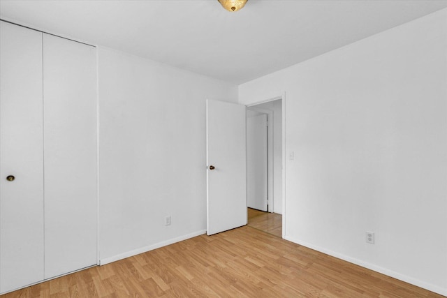 2407 W William St, Champaign, IL 61821 - unfurnished bedroom featuring light wood-style floors and a closet