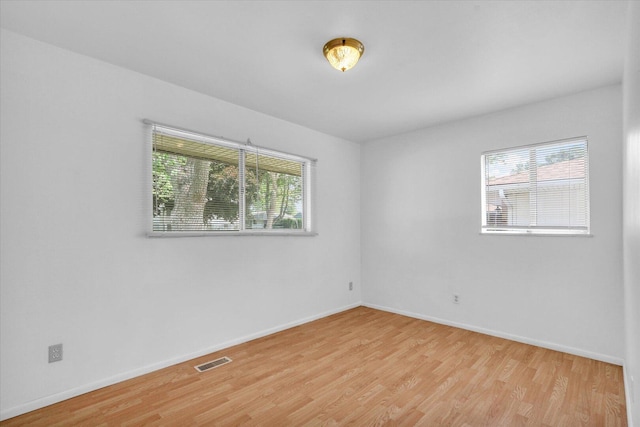 2407 W William St, Champaign, IL 61821 - spare room with wood finished floors and baseboards