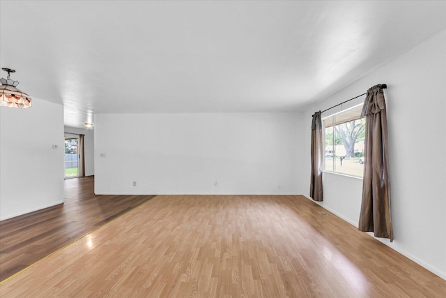 2407 W William St, Champaign, IL 61821 - unfurnished living room with wood finished floors and plenty of natural light