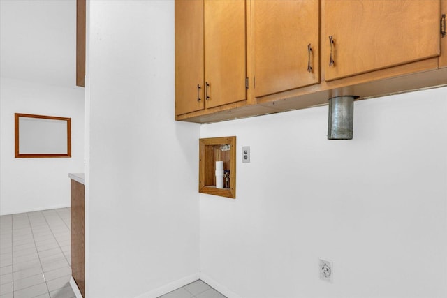 2407 W William St, Champaign, IL 61821 - laundry area featuring electric dryer hookup, cabinet space, and light tile patterned floors