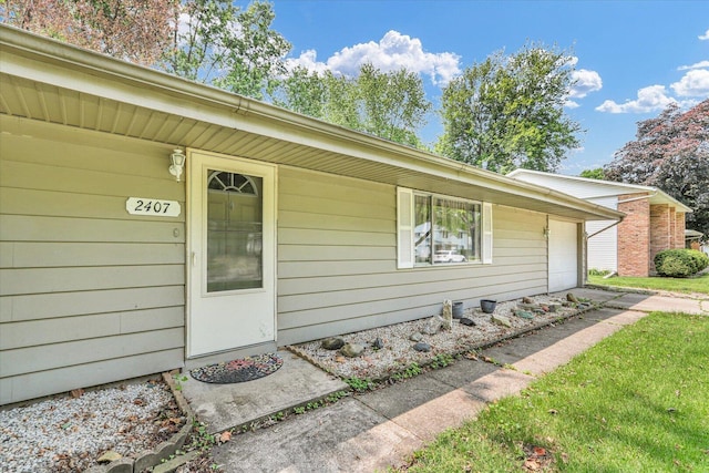 2407 W William St, Champaign, IL 61821 - view of exterior entry with an attached garage