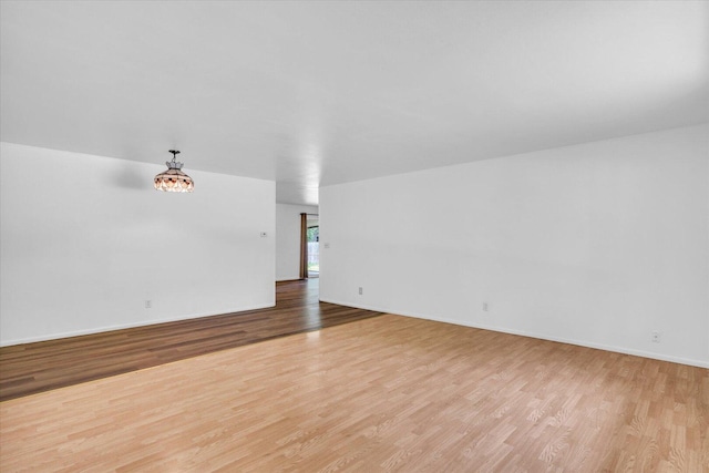 2407 W William St, Champaign, IL 61821 - spare room featuring light wood-type flooring and baseboards