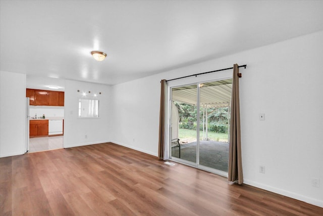 2407 W William St, Champaign, IL 61821 - unfurnished living room with light wood finished floors and baseboards