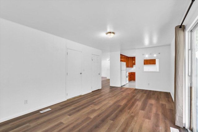 2407 W William St, Champaign, IL 61821 - unfurnished living room featuring dark wood-style flooring and baseboards