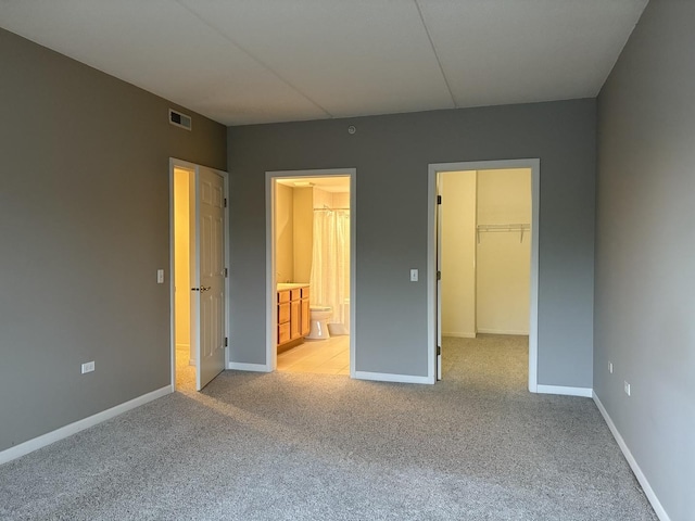 200 N Addison Ave Unit 505, Elmhurst, IL 60126 - unfurnished bedroom featuring light colored carpet, a spacious closet, ensuite bathroom, and a closet