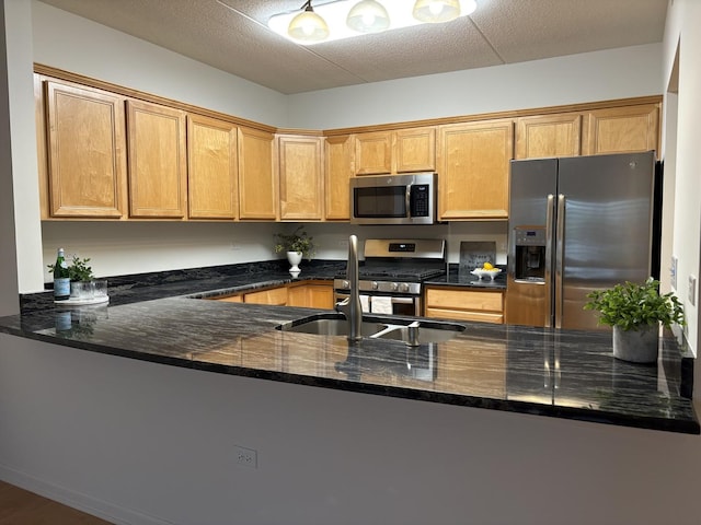 200 N Addison Ave Unit 505, Elmhurst, IL 60126 - kitchen featuring appliances with stainless steel finishes, dark stone counters, and a peninsula