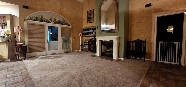 2S720 Nelson Lake Rd, Batavia, IL 60510 - unfurnished living room with a high ceiling, stone tile flooring, and a fireplace with flush hearth