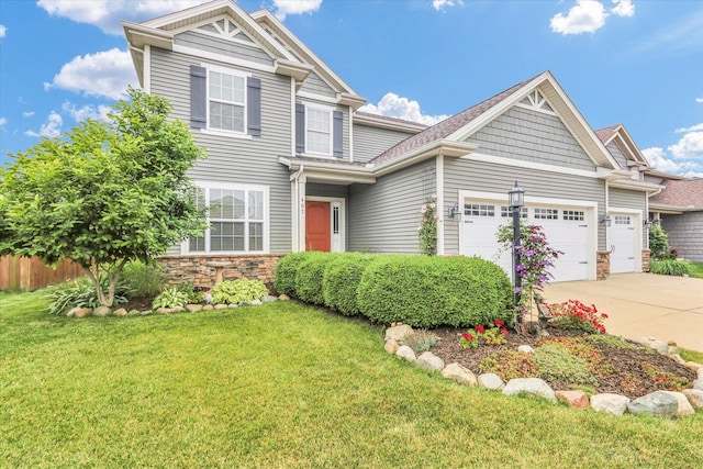 407 Banbury Ln, Savoy, IL 61874 - view of front of house with an attached garage, driveway, and stone siding