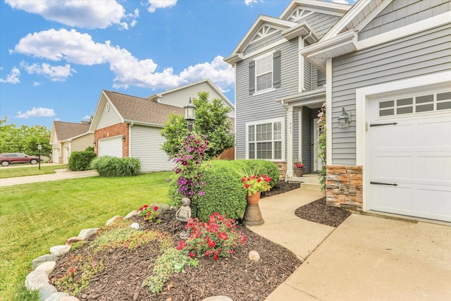 407 Banbury Ln, Savoy, IL 61874 - view of front of property featuring a front yard, stone siding, and an attached garage