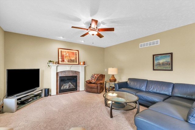 407 Banbury Ln, Savoy, IL 61874 - carpeted living room featuring a ceiling fan and a tile fireplace