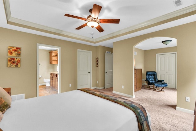 407 Banbury Ln, Savoy, IL 61874 - bedroom featuring arched walkways, a tray ceiling, light carpet, ensuite bath, and crown molding