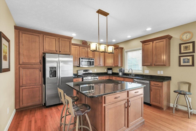 407 Banbury Ln, Savoy, IL 61874 - kitchen with stainless steel appliances, light wood finished floors, brown cabinets, and recessed lighting