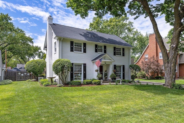 233 S Elmwood Dr, Aurora, IL 60506 - colonial-style house with a chimney and brick siding