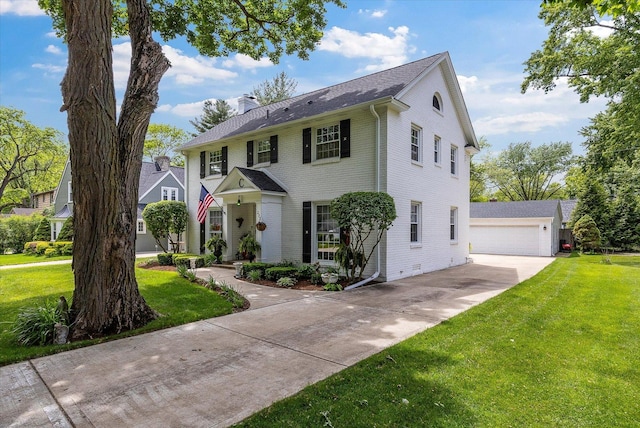 233 S Elmwood Dr, Aurora, IL 60506 - colonial home with a front yard, a chimney, brick siding, and an outdoor structure