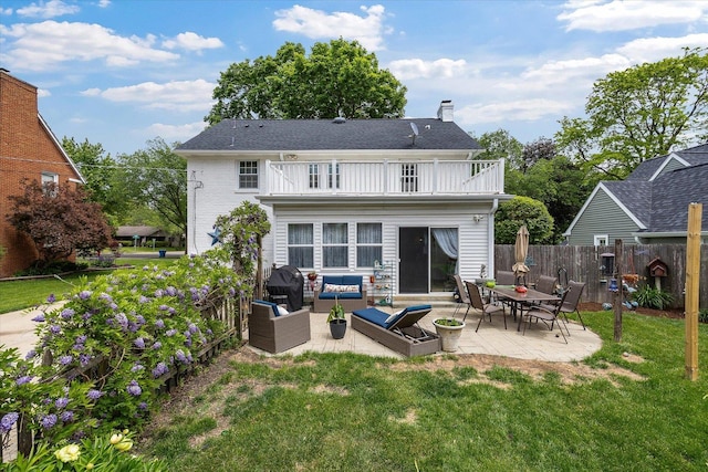 233 S Elmwood Dr, Aurora, IL 60506 - back of property with a balcony, outdoor lounge area, a chimney, and a patio area