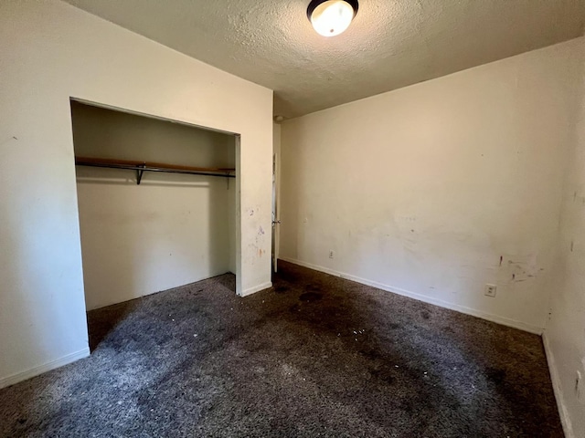 1205 W Beech St, Urbana, IL 61801 - unfurnished bedroom with carpet, a textured ceiling, and a closet