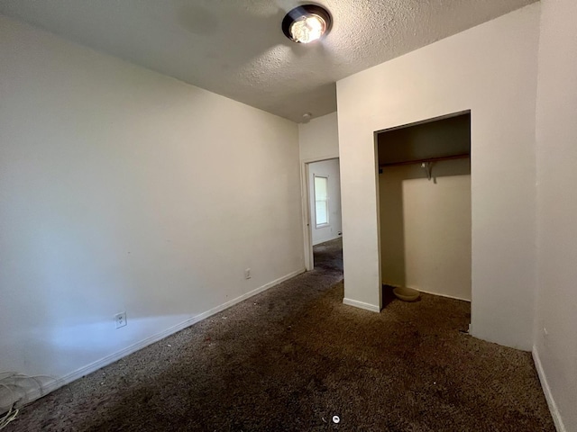 1205 W Beech St, Urbana, IL 61801 - unfurnished bedroom featuring carpet flooring, a textured ceiling, and a closet