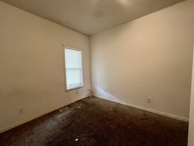 1205 W Beech St, Urbana, IL 61801 - spare room with dark carpet and baseboards