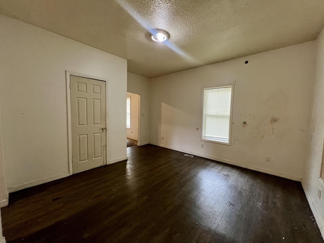 1205 W Beech St, Urbana, IL 61801 - spare room with dark wood-style floors and a textured ceiling