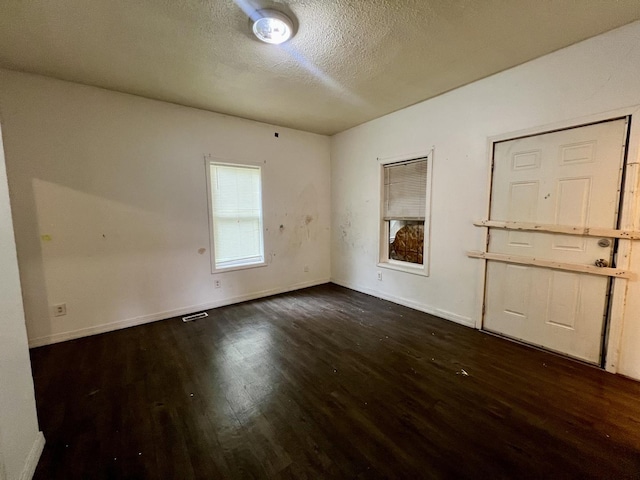 1205 W Beech St, Urbana, IL 61801 - empty room with dark wood-style flooring and a textured ceiling