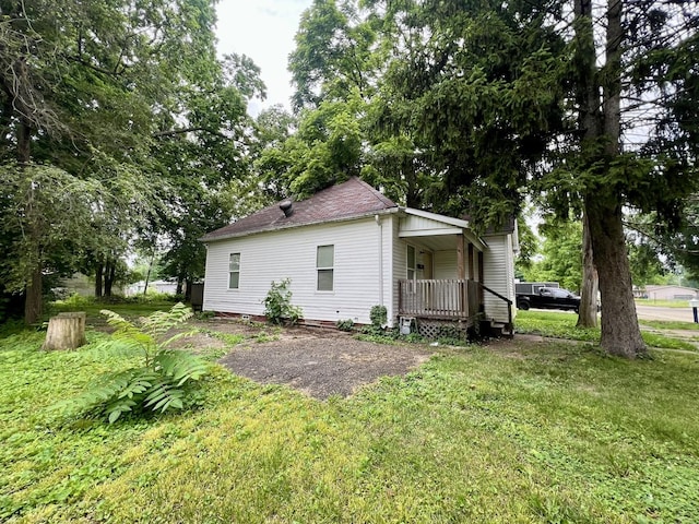 1205 W Beech St, Urbana, IL 61801 - rear view of property featuring a porch, a yard, and a shingled roof