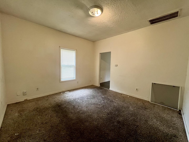 1205 W Beech St, Urbana, IL 61801 - spare room with dark carpet and a textured ceiling