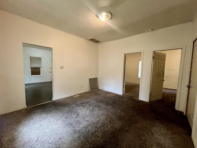 1205 W Beech St, Urbana, IL 61801 - unfurnished bedroom with a textured ceiling and carpet flooring