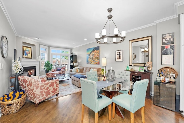 2500 N Seminary Ave Unit 4W, Chicago, IL 60614 - dining room featuring wood finished floors, a chandelier, crown molding, a lit fireplace, and recessed lighting