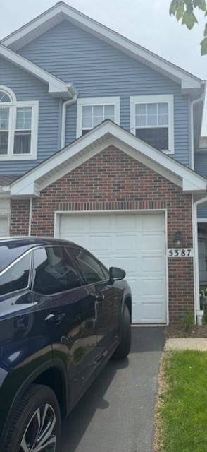 5387 Elizabeth Pl Unit 1302, Rolling Meadows, IL 60008 - view of side of home featuring brick siding and a garage