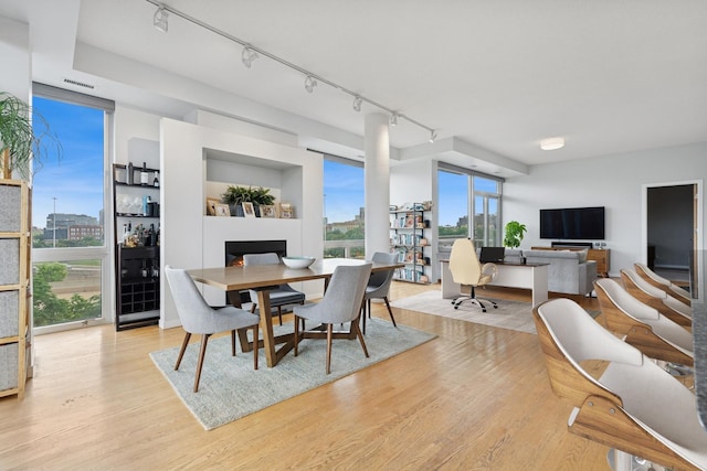 1035 W Huron St Unit 402, Chicago, IL 60642 - dining room featuring rail lighting, light wood-style floors, and an office area