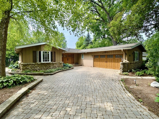 249 Jervey Ln, Bartlett, IL 60103 - ranch-style home featuring stone siding, a garage, decorative driveway, and board and batten siding