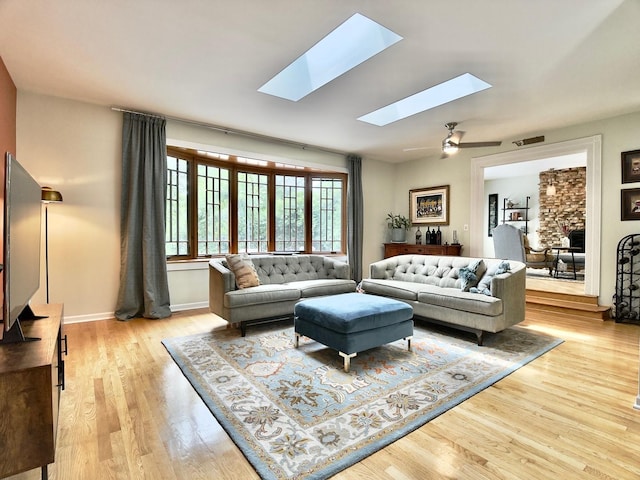 249 Jervey Ln, Bartlett, IL 60103 - living area featuring a skylight, wood finished floors, and a stone fireplace