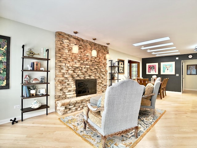 249 Jervey Ln, Bartlett, IL 60103 - living room featuring light wood-style flooring, a skylight, and a large fireplace