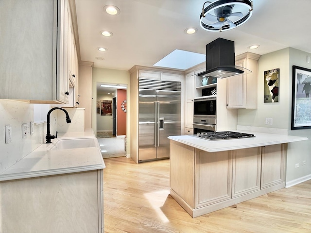 249 Jervey Ln, Bartlett, IL 60103 - kitchen featuring built in appliances, a peninsula, open shelves, light wood-style flooring, and light countertops