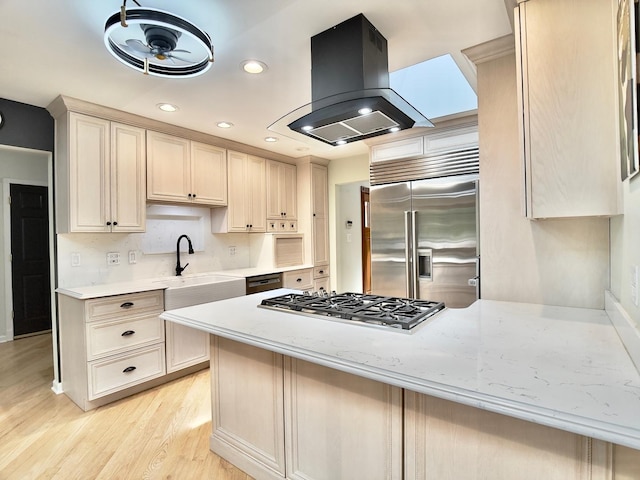 249 Jervey Ln, Bartlett, IL 60103 - kitchen with wall chimney range hood, stainless steel appliances, light wood-style floors, a peninsula, and recessed lighting