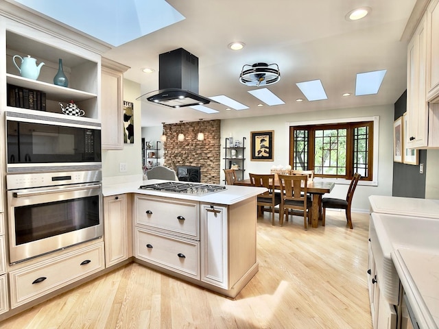 249 Jervey Ln, Bartlett, IL 60103 - kitchen featuring appliances with stainless steel finishes, a skylight, a peninsula, light wood-type flooring, and recessed lighting