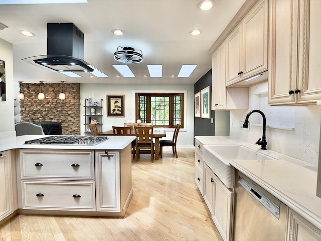 249 Jervey Ln, Bartlett, IL 60103 - kitchen with appliances with stainless steel finishes, a skylight, light wood-style floors, island range hood, and recessed lighting