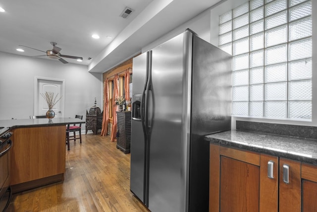 3316 W Byron St Unit 1, Chicago, IL 60618 - kitchen with stainless steel fridge, dark countertops, plenty of natural light, a ceiling fan, and recessed lighting